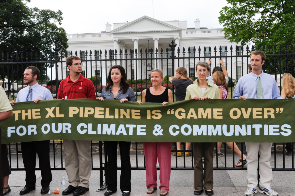Protesters of the Keystone XL Pipeline hold a banner in front of the White House before the sixth day of arrests on August 25, 2011 in Washington. Rena Schild/Shutterstock