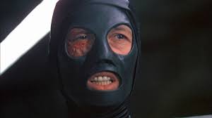 Frankenstein close-up in a black mask with eye and mouth holes.